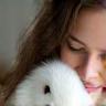 Young woman cuddling a rabbit